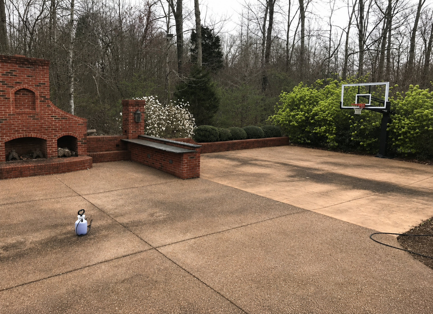 Before: stained residential patio and basketball court